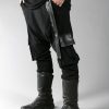 Black long loose pants for men designed with eco-leather and 2 pockets on the side
