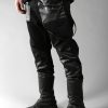 Black denim men pants designed with fake leather pocket on the front, leather pieces on the front lower leg and 2 pockets on back