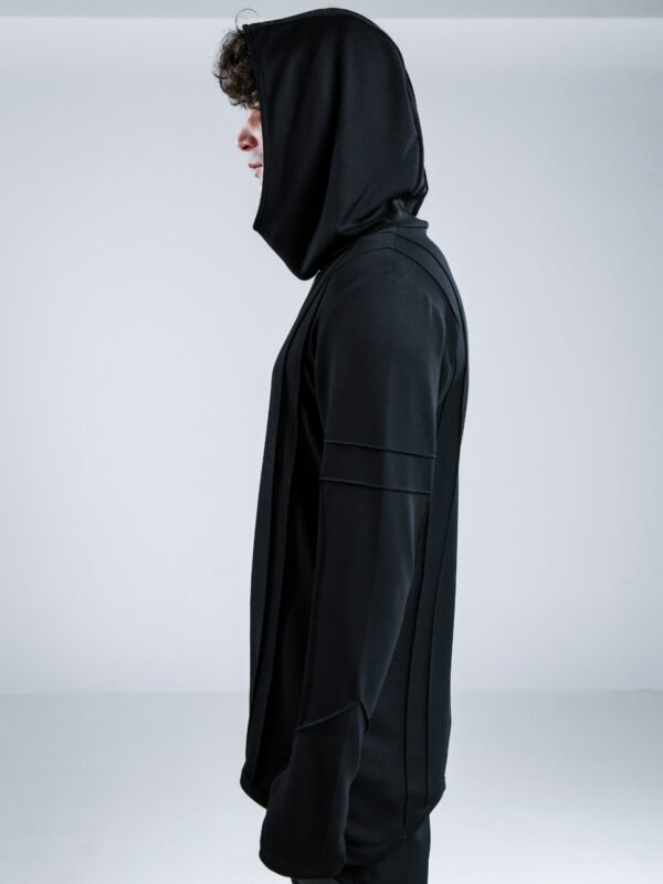 Black Sovereign Top by Kali Rose featuring an asymmetric silhouette, hood, long sleeves with thumbholes and distinctive pinch-stitch detailing, front and back views.