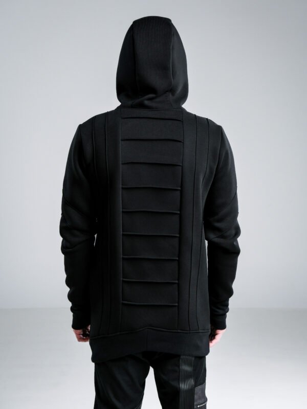 Black men's longline hoodie with high collar, front zipper, thumbholes and architectural pinch-stitch details, front and back views.