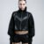 Black cropped women's jacket with high collar, voluminous sleeves, thumbholes and geometric faux leather detailing, front and back views.