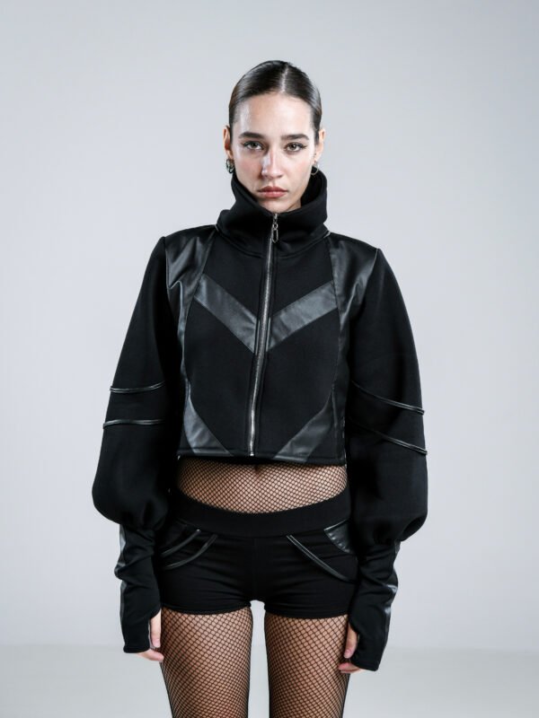 Black cropped women's jacket with high collar, voluminous sleeves, thumbholes and geometric faux leather detailing, front and back views.
