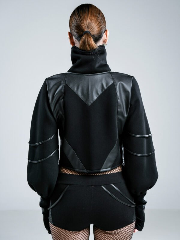 Black cropped women's jacket with high collar, voluminous sleeves, thumbholes and geometric faux leather detailing, front and back views.